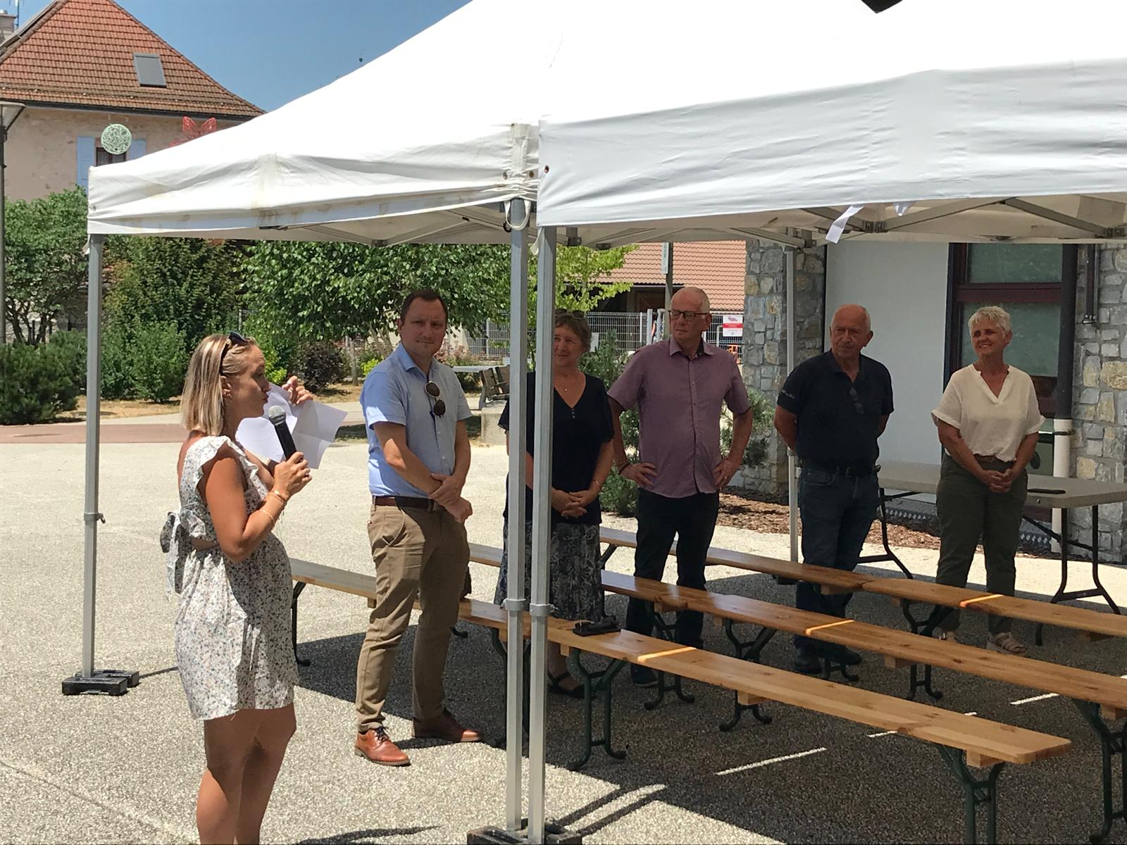 Groupe de personnes dont 1 personne parlant dans un micro